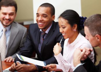 Multi ethnic business team at a meeting. Interacting. Focus on woman