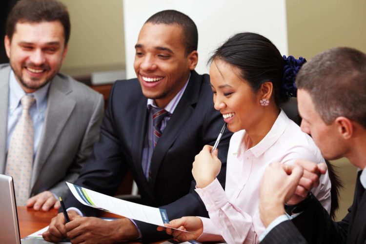 Multi ethnic business team at a meeting. Interacting. Focus on woman