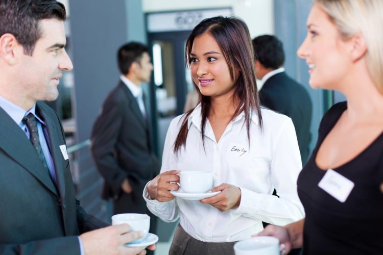 businesspeople interacting during coffee break at business conference