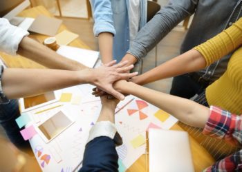 Hands of group of businesspersons showing teamwork