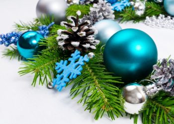 Merry Christmas background with silver, blue, turquoise baubles, fir branches and pine cones wreath