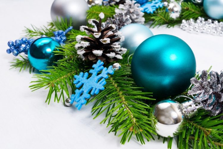 Merry Christmas background with silver, blue, turquoise baubles, fir branches and pine cones wreath